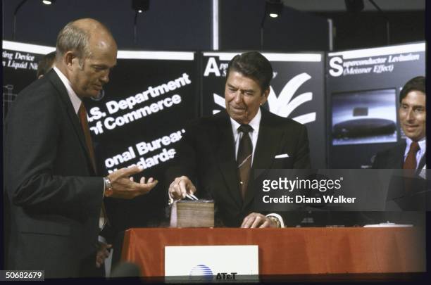 President Ronald W. Reagan at Superconductivity conference using tweezers.