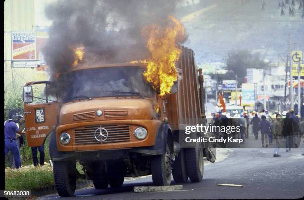 Flames engulfing vehicle set afire by students, workers & peasants who are protesting assassination of Human Rights Comm. President Herbert Anaya...
