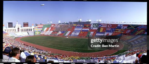 Opening ceremonies of the Summer Olympics witt flags in stands.