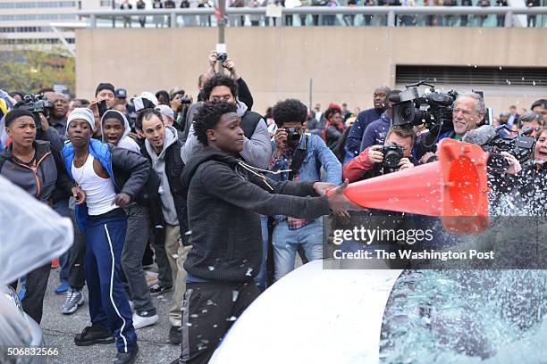 These protester destroy vehicles and police vehicles in downtown Baltimore after Hundreds marched from West Baltimore to the City Hall and then...