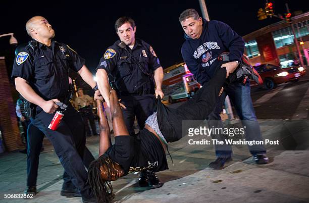 Protestor, defying the 10PM curfew, is arrested near the intersection of Pennsylvania and North Avenue in Baltimore, Maryland, on Saturday, May 2,...