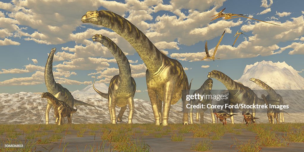 Hypsilophodon and pteranodon dinosaurs accompany a herd of Argentinosaurus.