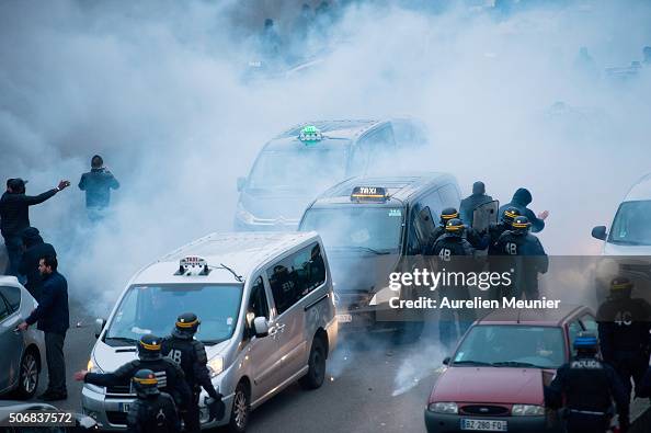 Riot Police Use Tear Gas As Taxi Drivers Demonstrate By Blocking The 