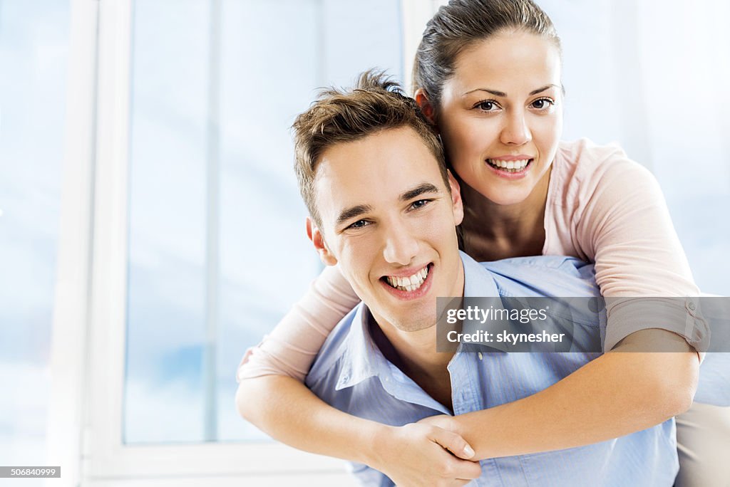 Happy young couple piggybacking.