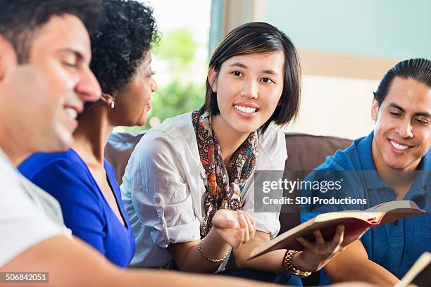 young asian woman leading bible study group at home - church group stock pictures, royalty-free photos & images