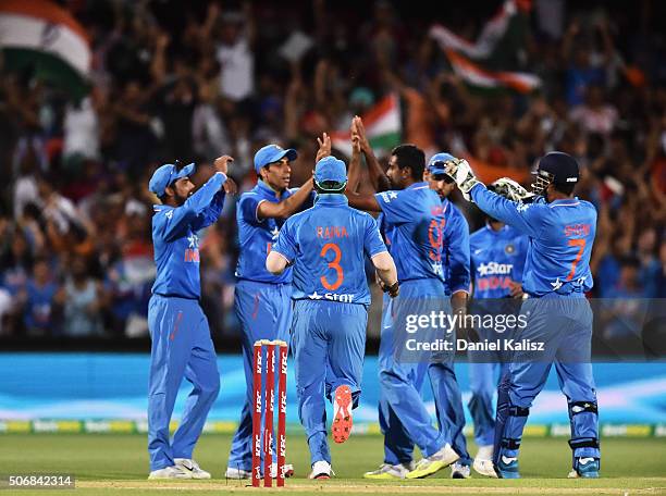 India celebrate after Ashish Nehra of India takes a catch to dismiss Shane Watson of Australia of the bowling of Ravichandran Ashwin of India during...