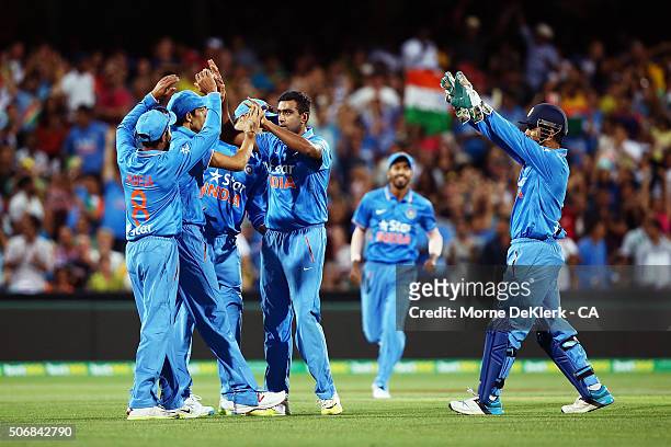 Ravichandran Ashwin of India celebrates with teammates after taking the wicket of Shane Watson of Australia during game one of the Twenty20...