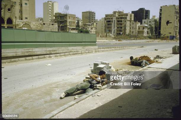 Druse PSP, , militiamen take cover from sniper fire at Barbir section of museum Green Line crossing between W/E Beirut, during internecine fighting.