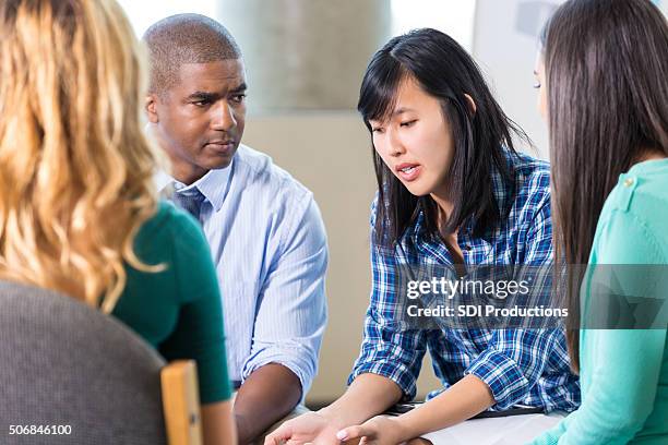 emotional asian woman talks in group therapy - african american man depressed bildbanksfoton och bilder