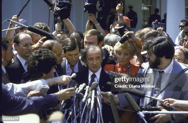 Author/Holocaust Comm. Chrmn. Elie Wiesel with Sen. Alfonse D'Amato and press after being awarded the Congressional Gold Medal by US Pres. Ronald W....