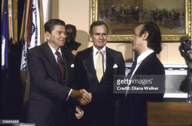 Author/Holocaust Comm. Chrmn. Elie Wiesel shaking hands with US Pres. Ronald W. Reagan during presentation ceremony of Congressional Gold Medal with...