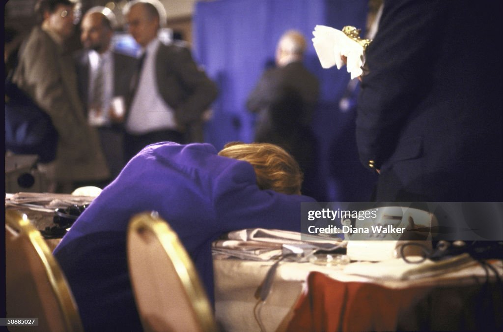 An exhausted woman reporter slumping ove