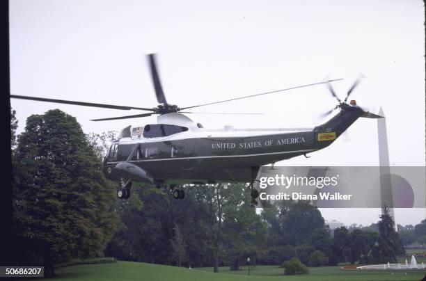 View of Marine One taking off with the Washington Monument in the background.