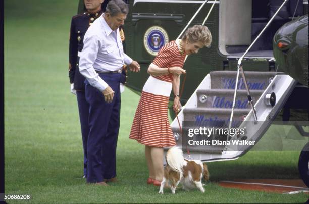 President Ronald W. Reagan, his wife Nancy, and their dog boarding Marine One copter ONTHEIR WAY TO cAMP dAVID.