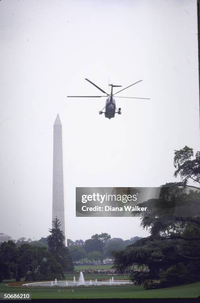 View of Marine One taking off with the Washington Monument in the background.