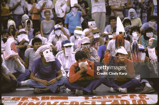 Leftist university students wearing face masks and carrying flaming torches while protesting at the US Embassy.