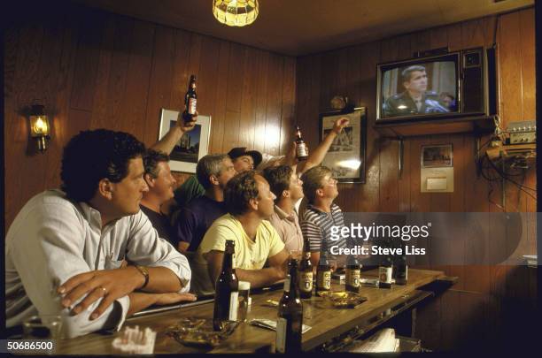 Patrons at a pub watching TV to see Lt. Col. Oliver L. North's testimony before the joint Congressional hearing into Iran-Contra affair.