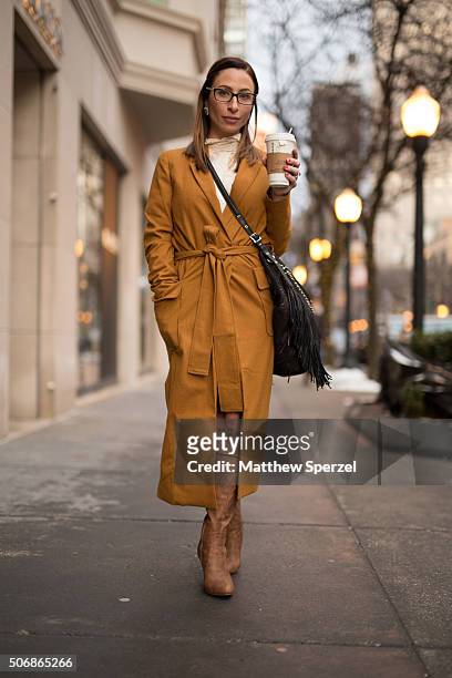 Kelli Weiss is seen on Oak Street wearing Tiffany glasses, camel wool Akira coat, cream lace Blue Planet dress, brown leather Union 14 boots, and...