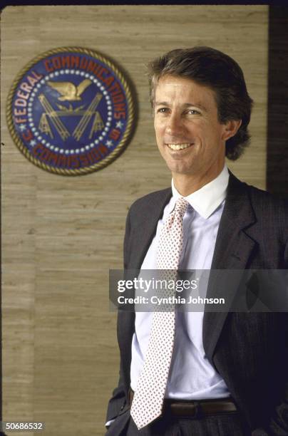 Chairman of the FCC Denis Patrick posing in his office with the FCC seal in the background.