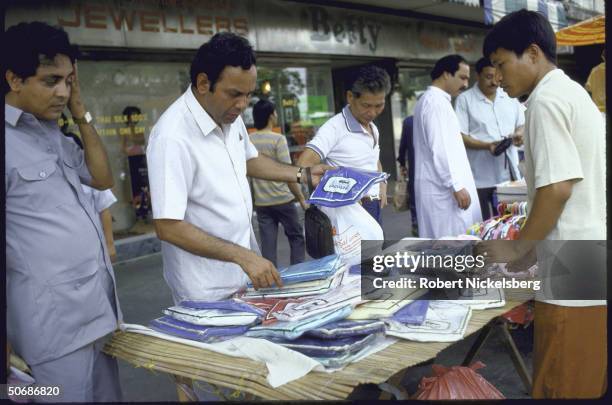 Vendors selling copies of Lacoste & Benetton shirts.