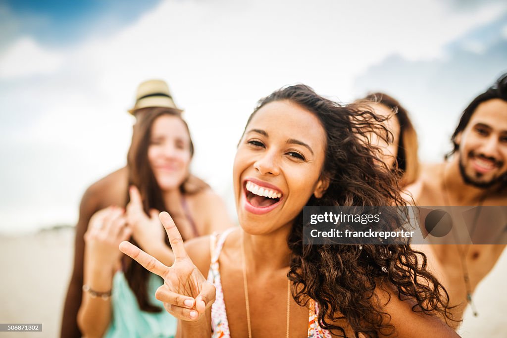 Friends dancing on the beach for a party