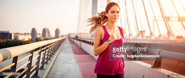 sportswoman during jogging in the morning - run watch stock pictures, royalty-free photos & images