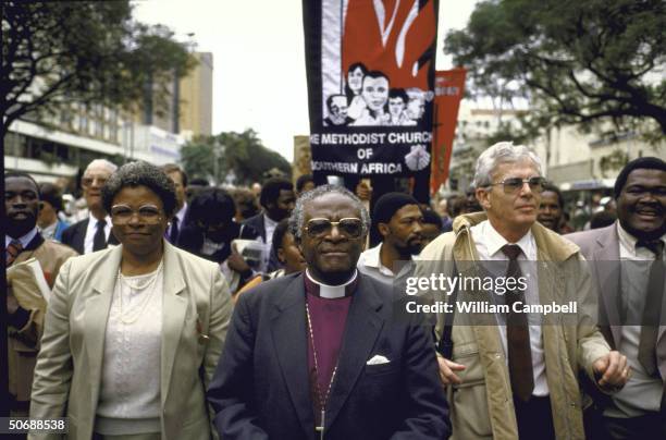 South African Anglican Bishop Desmond M. Tutu marching with members of Southern Africa Methodist Church singing freedom songs.