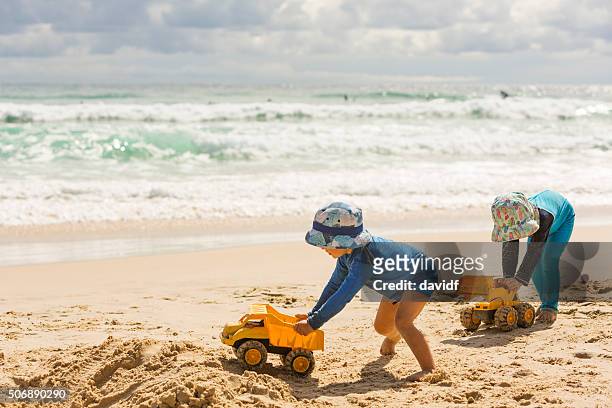 boys digging in the sand at the beach - toy truck stock pictures, royalty-free photos & images