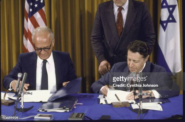 Israeli Defense Minister Itzhak Rabin and Defense Secretary Casper W. Weinberger signing SDI agreement, making Israel the third nation to join Star...