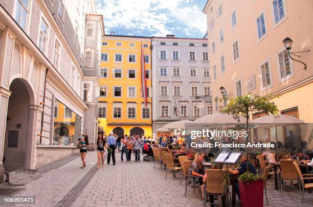 View of house number 9 in Getreidegasse yellow facade in the city of Salzburg where Wolfgang Amadeus Mozart was born and lived until the age of 17,...