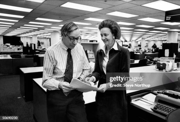 Washington Post publisher Katharine Graham chatting w. Managing editor Howard Simmons in the newsroom.