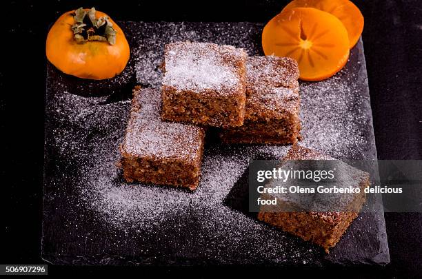 persimmon cake with sugar powder - persimone stock-fotos und bilder