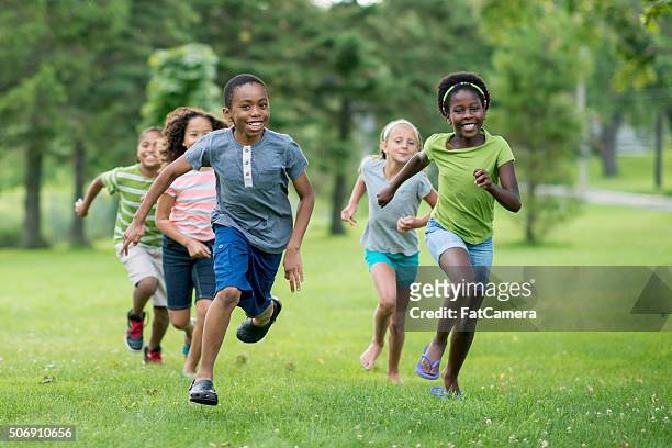 happily playing tag - boy girl stock pictures, royalty-free photos & images