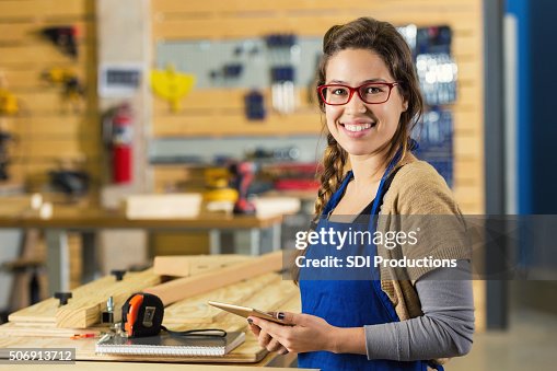Young carpentry apprentice using digital tablet while while building furniture Young carpentry apprentice using digital tablet while while building furniture