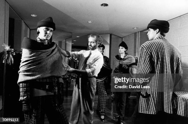 Designer Gianni Versace fitting a model in his showroom.