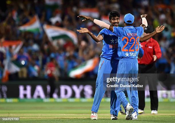 Jasprit Bumrah of India celebrates with Hardik Pandya of India after taking a catch to dismiss Cameron Boyce of Australia and to win the game for...