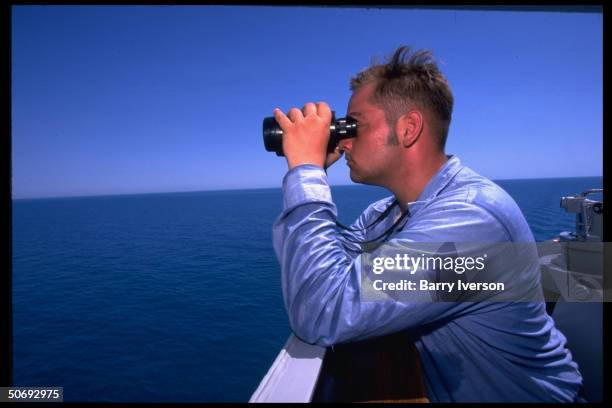 Doyle frigate crewman scanning horizon after sighting dhow cargo vessel bound for Iraqi Shat al-Arab waterway, enforcing UN Maritime Interception OP...