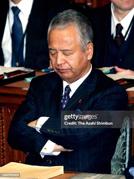 Economy Revitalization Minister Akira Amari closes his eyes during the party leaders question at a plenary session of the lower house at the diet...