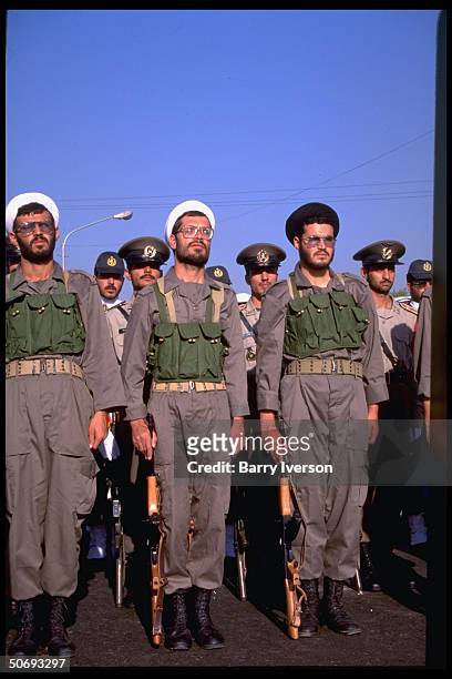 Revolutionary Guard soldiers incl. Basidjis, Islamic volunteers, in their midst leading troops marching in military parade kicking off sacred defense...