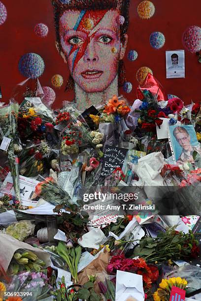 Flowers, letters and other items left on a mound continue to grow two weeks after the death of Brixton born English singer, songwriter David Bowie at...