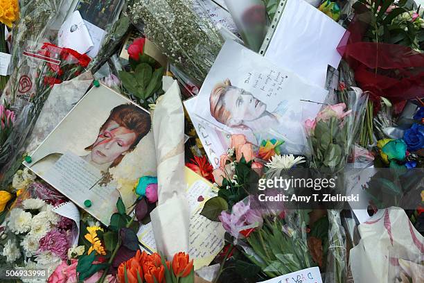 Detail view of the flowers, letters and other items left on a mound continue to grow two weeks after the death of Brixton born English singer,...