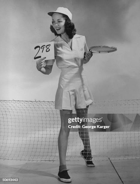 Sears model clad in tennis outfit, holding $2.98 price tag, right out of Sears catalog.