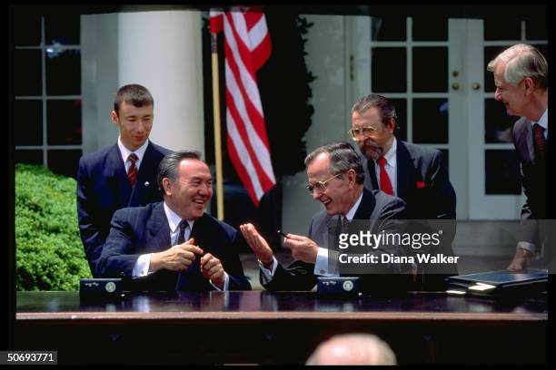 Presidents Nursultan Nazarbayev of Kazakhstan & George Bush during treaty signing ceremony outside White House.