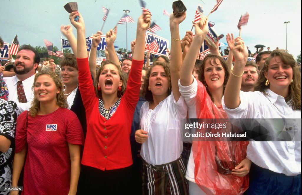 Enthused girls at head of crowd cheering