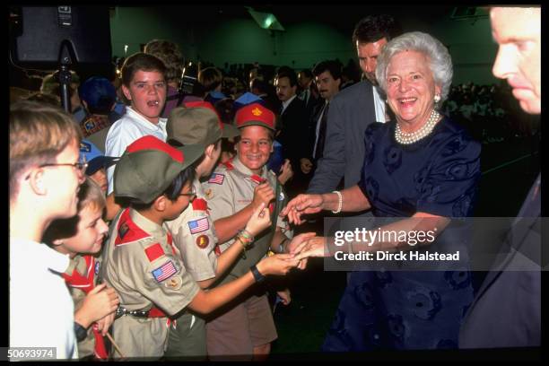 First Lady Barbara Bush greeting children, shaking hands, visiting Singapore American school.