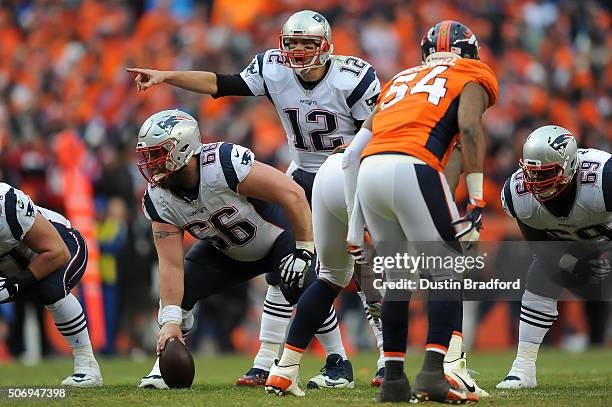 Tom Brady of the New England Patriots runs the offense against the Denver Broncos in the AFC Championship game at Sports Authority Field at Mile High...