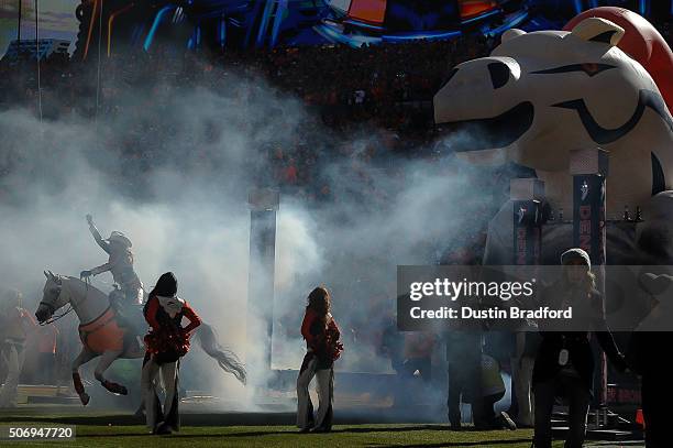 Equestrian Ann Judge-Wegener rides Denver Broncos mascot 'Thunder' out of the tunnel during player introductions during the pre game ceremony before...