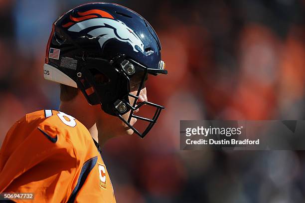 Peyton Manning of the Denver Broncos warms up on the field before the AFC Championship game against the New England Patriots at Sports Authority...