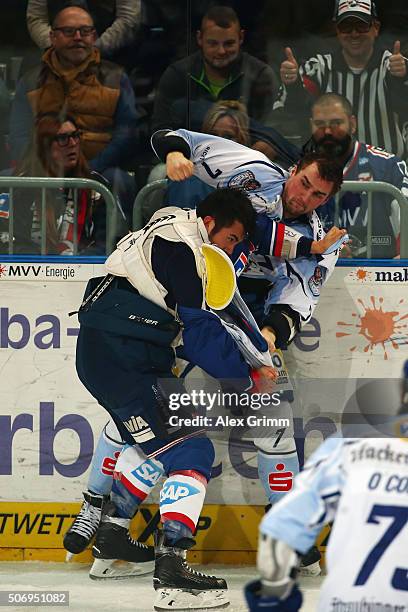 Brandon Yip of Mannheim fights with Colton Jobke of Straubing during the DEL match between Adler Mannheim and Straubing Tigers at SAP Arena on...