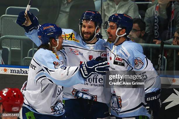 Mike Hedden of Straubing celebrates his team's third goal with team mates Dylan Yeo and Steven Zalewski of Straubing during the DEL match between...